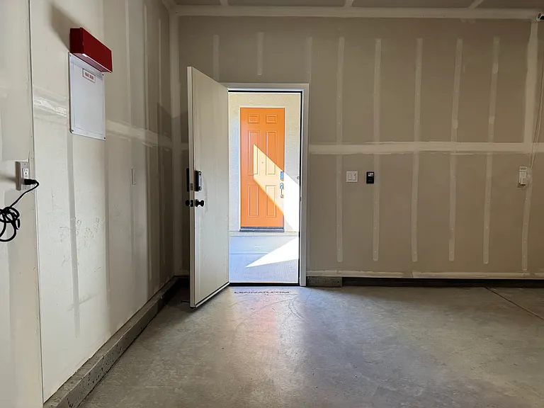 View from inside 1-car garage bay looking towards the front entrance door.