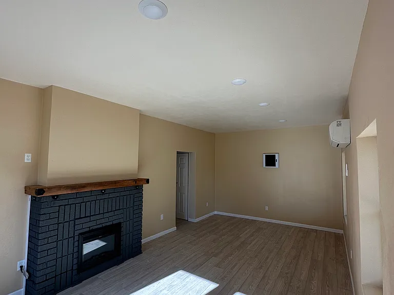 Looking from the front door to the door that goes to the hallway to the stackable washer dryer closet. This hall goes to the kitchen.
