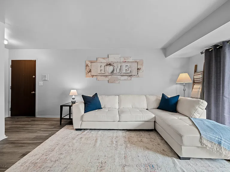 Spacious living room with natural light at Westwood Village Apartments in Westland, MI