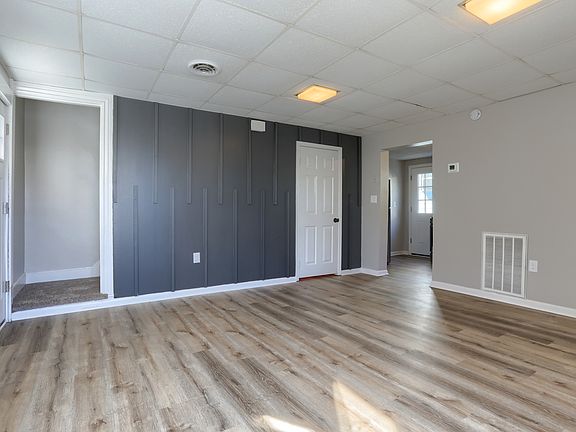 Living room. Half bathroom behind white door