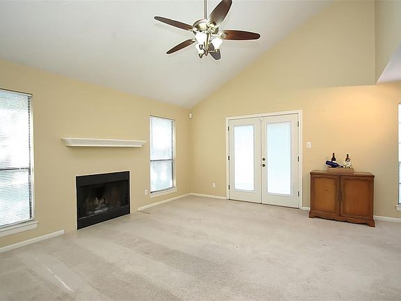 HERE YOU ARE VIEWING THE FAMILY ROOM FROM A DIFFERENT ANGLE WHICH ALLOWS YOU TO SEE THE DOUBLE FRENCH DOORS THAT LEAD BACK TO THE COURTYARD AND THE LARGE BACKYARD! THE COZY FIREPLACE AND MANTLE IS A FINAL TOUCH TO AN AWESOME ROOM!!!