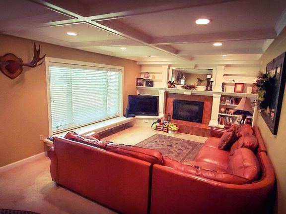 Family room with gas fireplace. Garage entry door on right. Auxiliary exit door on left