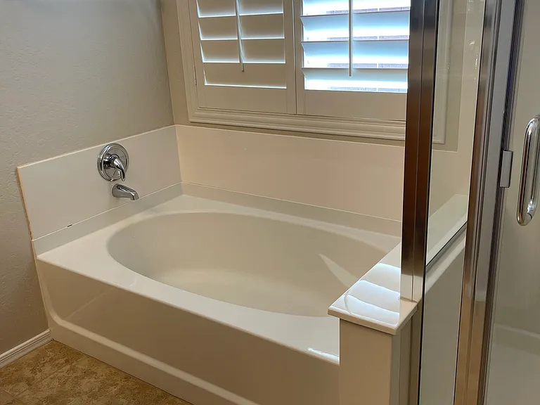 Primary tub with shower to the right.