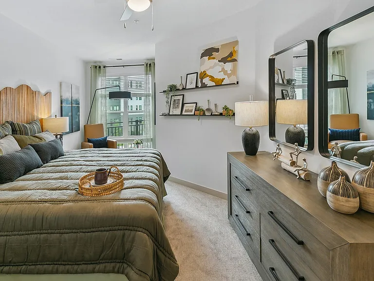 Wake up to modern comfort in this airy bedroom, complete with sleek design and soft, welcoming tones.