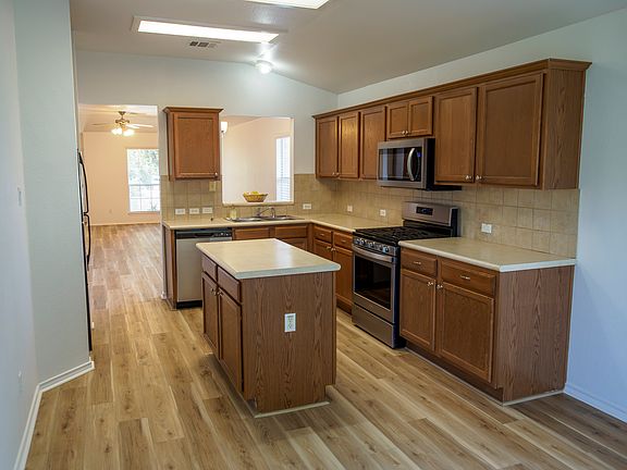 Quartz countertops and white matt backsplash tile, stack laid will be installed prior to move in. 
Quartz not shown in photo. Samples in the home to see if you should preview.