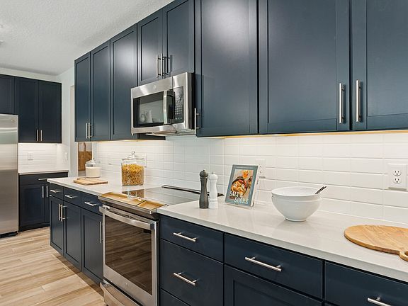 Kitchen with blue cabinets and quartz countertops