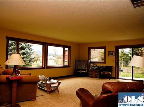 Living Room is filled with wood wrapped windows, and views looking out over incredible vistas. Roomy