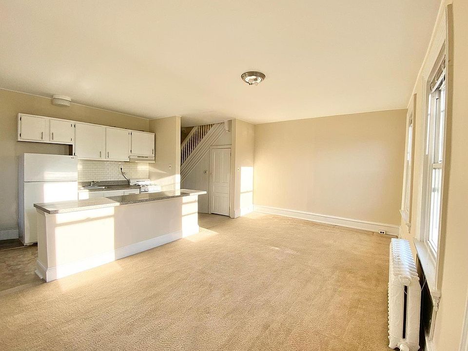 Open plan living room, dining area and kitchen with 5 large windows