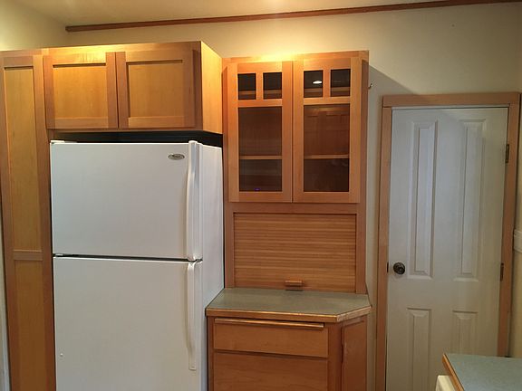 Kitchen looking W, showing 'fridge/freezer and door to basement