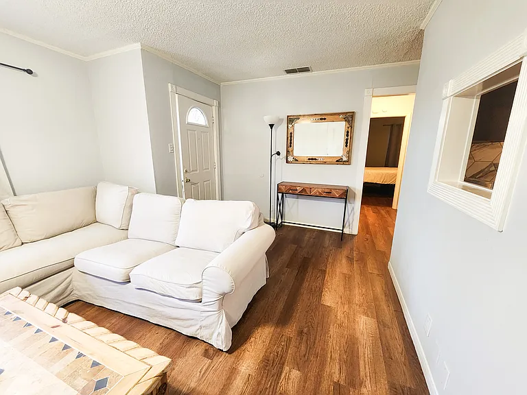 Living room but will not include the furniture. The hallway leads to the front bedroom, gray bedroom and hall bathroom