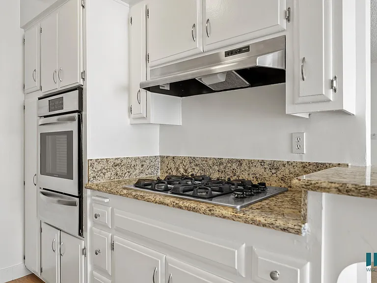 Kitchen with Granite Countertops, Stainless-Steel Stove, and Ample Cabinet Storage