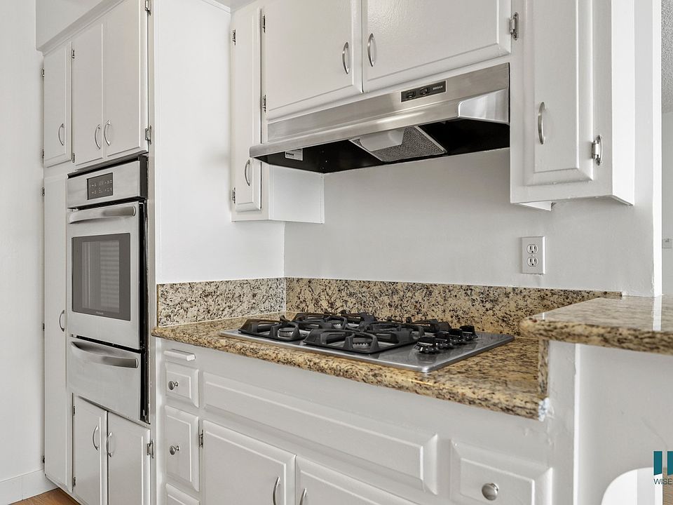 Kitchen with Granite Countertops, Stainless-Steel Stove, and Ample Cabinet Storage