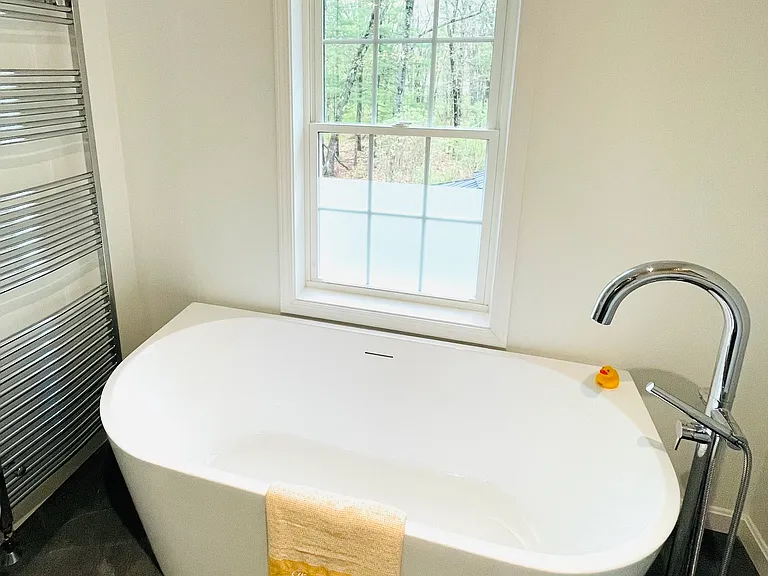 Bathroom: extra large bathtub and towel warmer