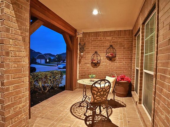 COVERED FRONT PORCH WITH BRICK FLOORING - Another view of the front covered patio - totally lined in brick. Located in Auburn Lakes, this community is nestled between towering trees, shimmering lakes and 2 beautifully manicured golf courses, Willow C
