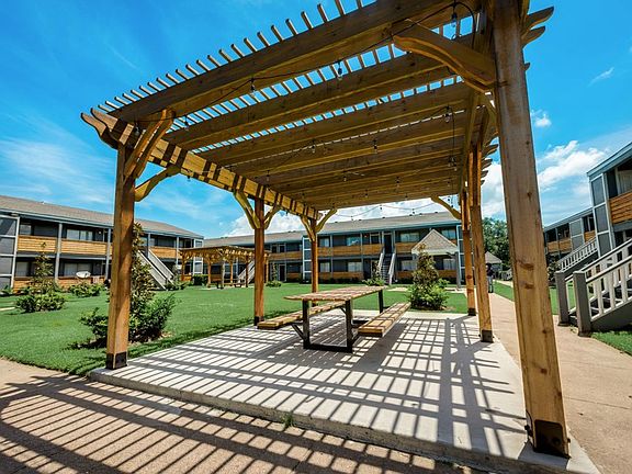 Outdoor pergola seating area perfect for relaxing and gathering with neighbors