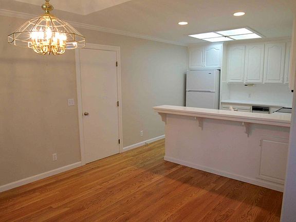 To the left of entrance, dining area and kitchen with bar. The door leads to a one-car garage.