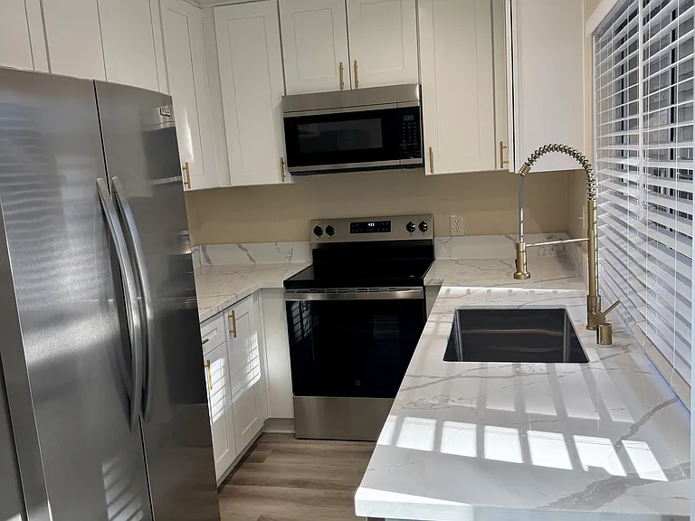 Brand new kitchen with new cabinets, quartz countertop, new appliances including double door fridge/ freezer