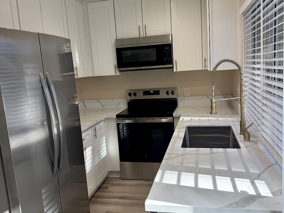 Brand new kitchen with new cabinets, quartz countertop, new appliances including double door fridge/ freezer