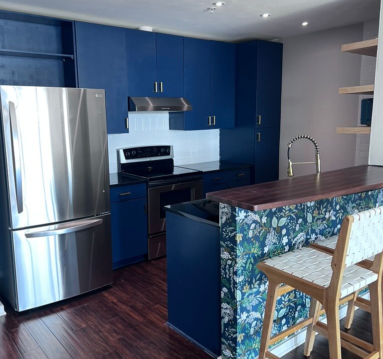 Open kitchen with breakfast bar and stainless steel appliances