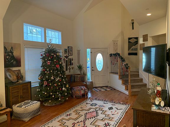 Living Room with stairs leading up to Primary Suites on 2nd story