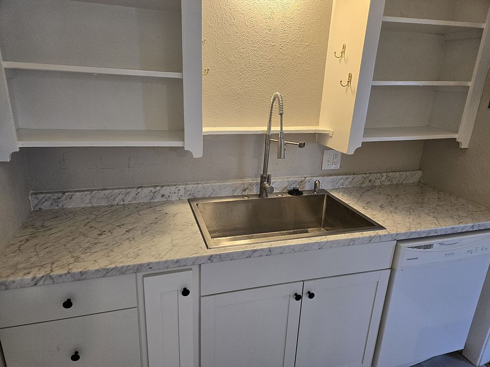 Remodeled kitchen with new cabinets, countertop, sink, faucet, and floor covering!