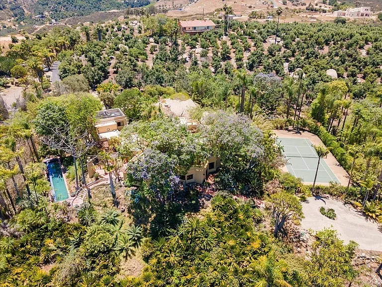 Birdseye view of house. Lap pool on the left, private tennis court on the right.