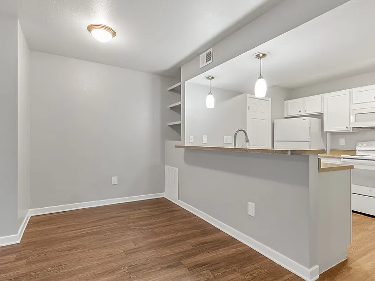 A Dining Room and Kitchen at The Buttes Apartment Homes in Loveland, CO