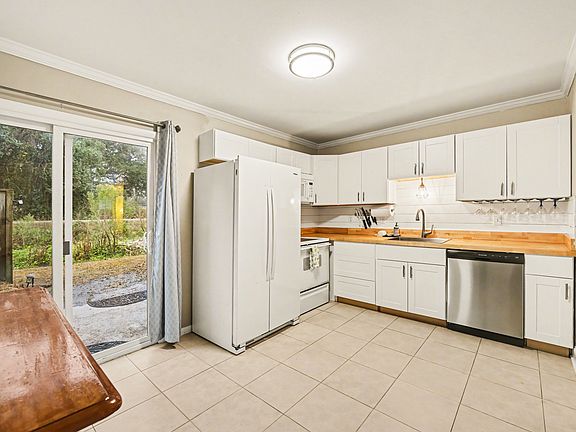 Kitchen and dining island with bar stool seating for 2