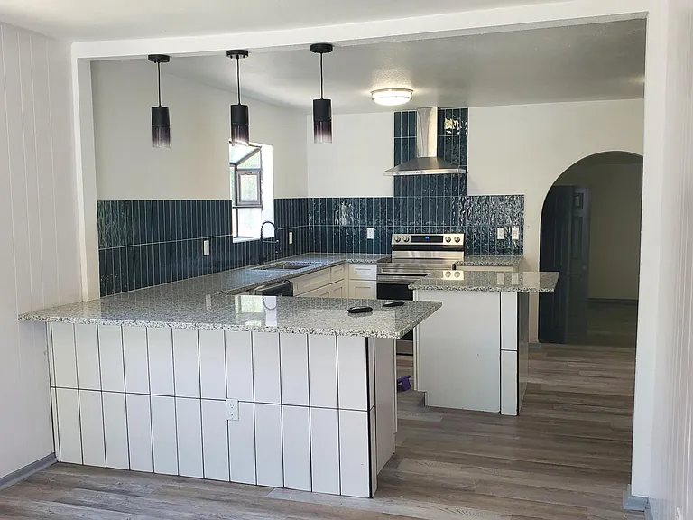 Spacious, open kitchen with plenty of seating at bar and Island. Granite countertops.