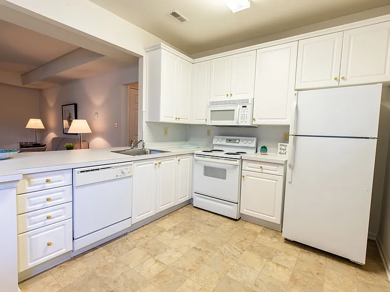 42" White kitchen cabinetry and white GE appliances in standard kitchen.