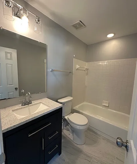 Updated master bathroom with new vanity, mirror, lights and floor