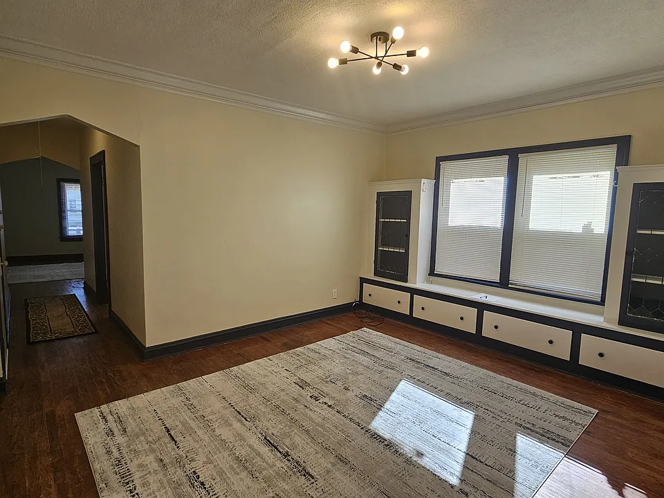 Freshly-painted dining room with new modern light fixture and blinds