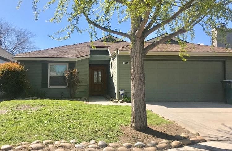 Beautiful glass and wood framed door. Low water yard. 2 car garage and driveway.