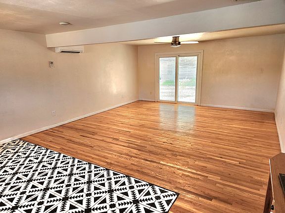 Open concept living room with sliding patio doors and screen