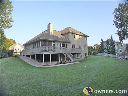 Large wrap-around deck and landscaped backyard.