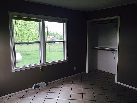 Bedroom with full size closet and tile throughout.