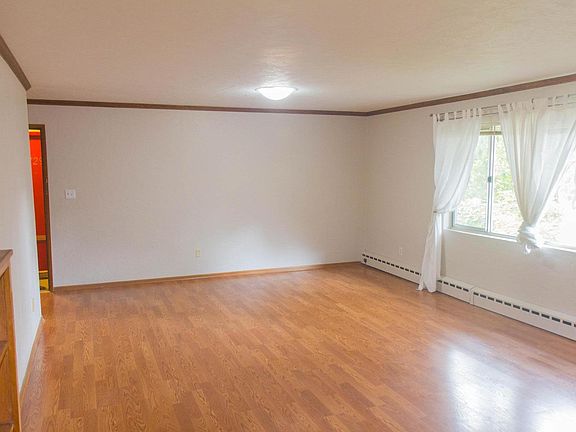 Living and dining area: unseen storage near entry