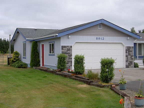Westside view; exterior exit from garage