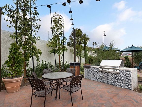 An outdoor barbeque and dining set at the East Lounge amenity