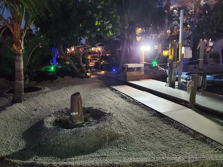 SANDY BEACH AREA WITH TIKI STATUE BAYSIDE