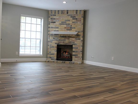 Fresh paint, fully functional gas fireplace and large windows for lots of natural light in living area. Door to the right enters primary bedroom.
