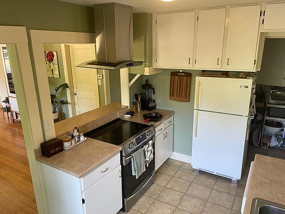 View of kitchen with panty in the background.