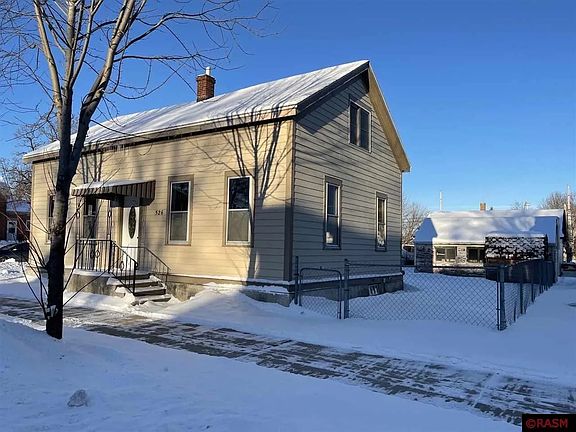 front/ side of house, partially fenced yard