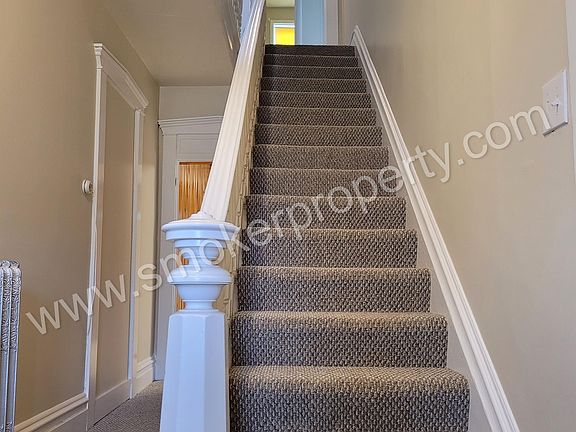 Front entrance. Steps leading to the bedrooms and full bathroom on the second floor