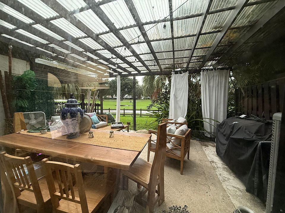 View from Master Bedroom overlooking covered patio toward the golf course