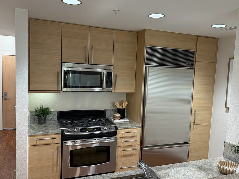 A fully equipped kitchen featuring premium appliances, including a state-of-the-art Sub-Zero refrigerator.