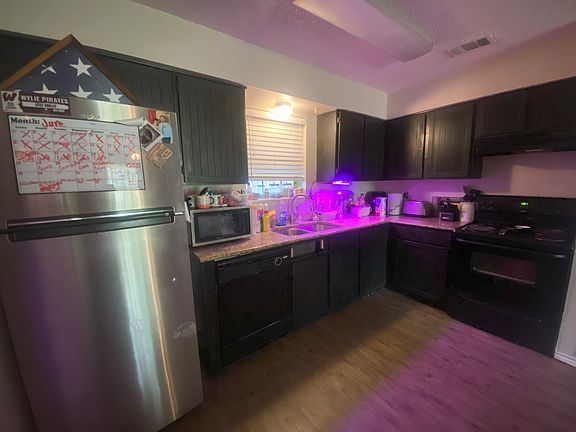 Kitchen has granite counter tops and has a window overlooking the backyard