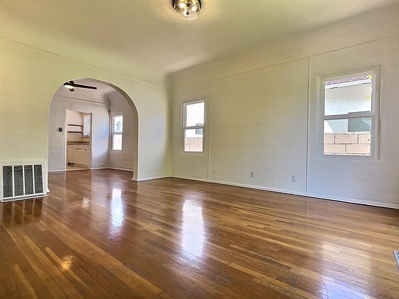 View from front door entrance looking into living room, dining room, and beyond that is the kitchen.