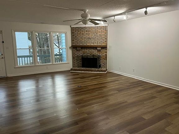 Living / Dining / Fireplace with view of rear deck