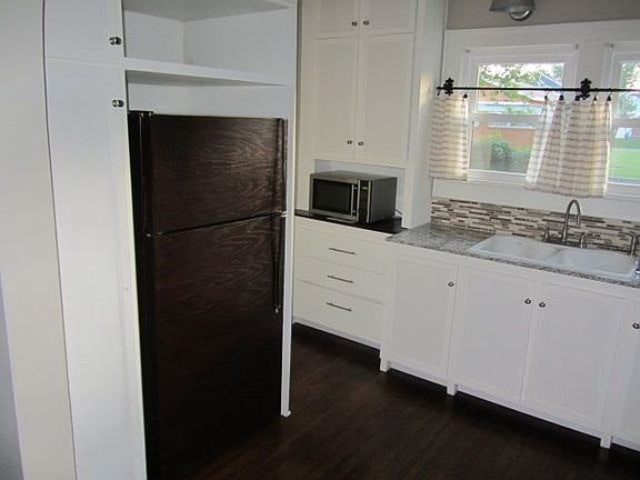 Kitchen with refrigerator,microwave, gas stove